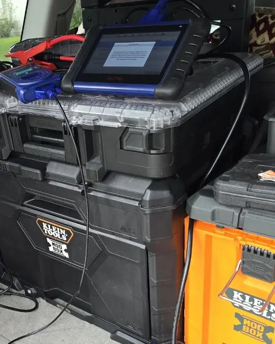 Key programming tools and tool cases set up in the back of the Athawri Locksmith truck