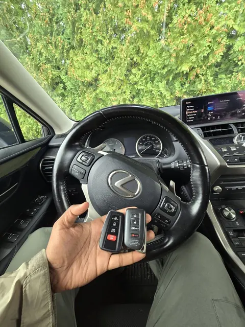 Two new Lexus smart keys in front of the steering wheel